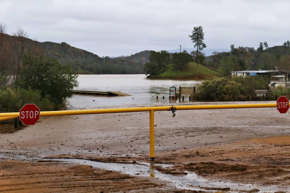 The Santa Margarita Lake marina is closed to public use until further notice due to flooding and muddy conditions after early January storms. Here, the public boat launch ramp sits underwater and a boat dock floats high on the lake.