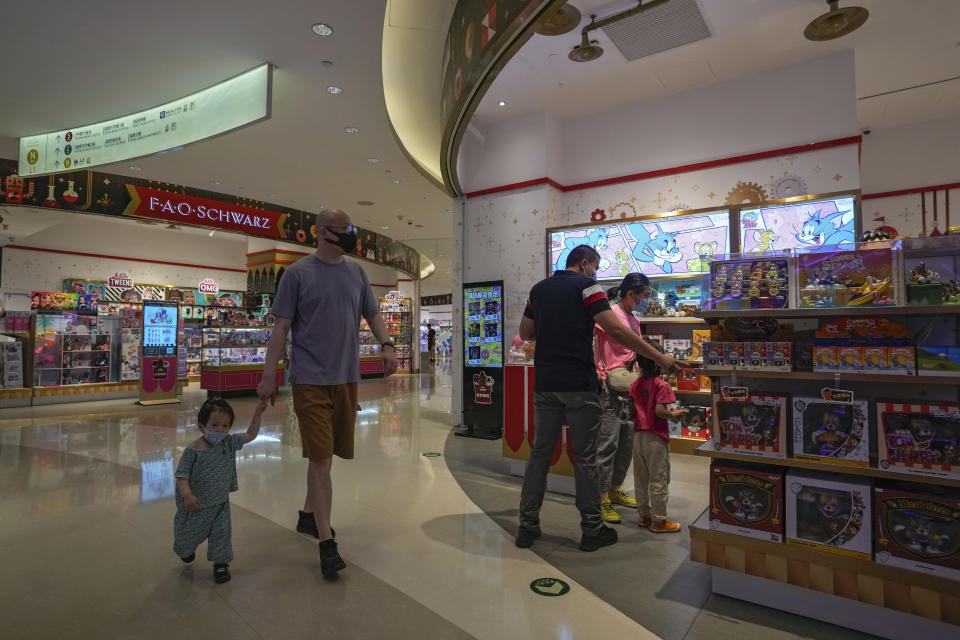 Residents wearing face masks visit a reopened mall after it was closed due to COVID-19 restrictions in Beijing, Sunday, May 29, 2022. (AP Photo/Andy Wong)