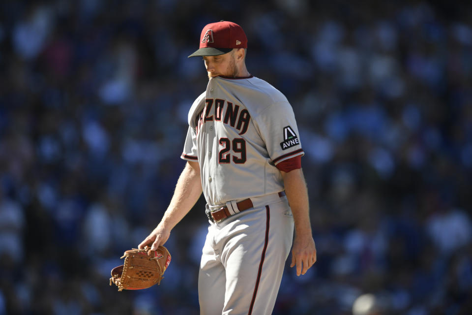 Arizona Diamondbacks' starting pitcher Merrill Kelly reacts after being pulled from the game during the sixth inning of a baseball game against the Chicago Cubs Saturday, Sept. 9, 2023, in Chicago. (AP Photo/Paul Beaty)