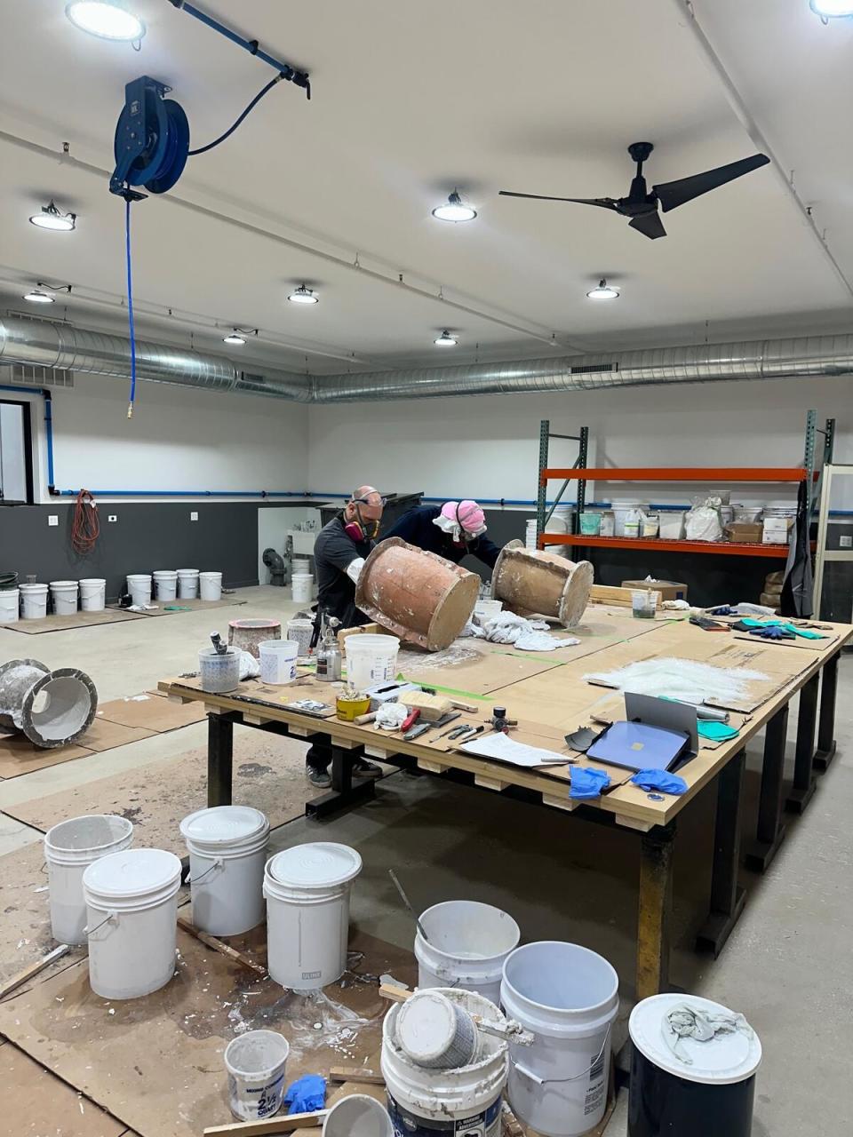 Craftsmen laying fiberglass in mold at Zachary A.