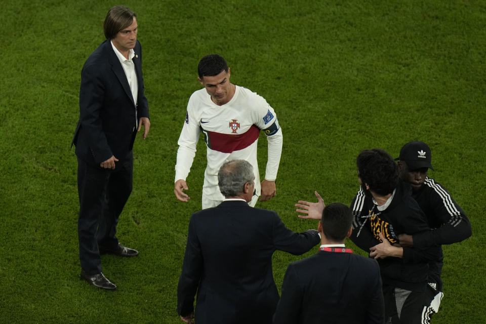 Portugal's Cristiano Ronaldo, center, reacts as he walks off the field after their loss in the World Cup quarterfinal soccer match against Morocco, at Al Thumama Stadium in Doha, Qatar, Saturday, Dec. 10, 2022. (AP Photo/Alessandra Tarantino)