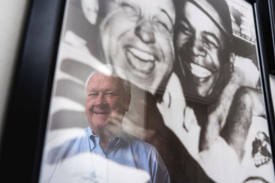 Gregory Gromek, of Beverly Hills, is reflected in a photo at his home on Wednesday, March 13, 2024. The photo is of Larry Doby and Gromek's father, Cleveland Indians pitcher Steve Gromek, from the 1948 World Series in which Doby hit the deciding home run. In 1947, Doby had become the first Black player in the American League, only 11 weeks after Jackie Robinson integrated Major League Baseball.