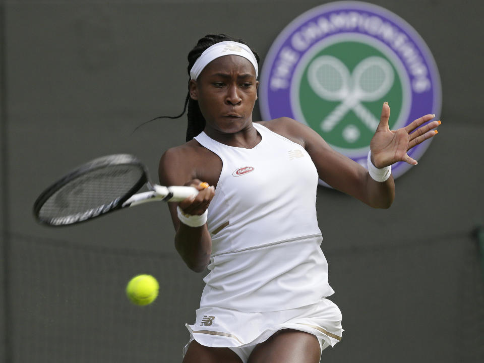 FILE - United States' Cori "Coco" Gauff serves to United States's Venus Williams in a women's singles match during day one of the Wimbledon Tennis Championships in London, Monday, July 1, 2019. Coco Gauff was 15 when she became the youngest player to qualify for Wimbledon and then made it all the way to the fourth round of the main draw. Who was the youngest woman to win a Grand Slam title since 2000? (AP Photo/Tim Ireland, File)