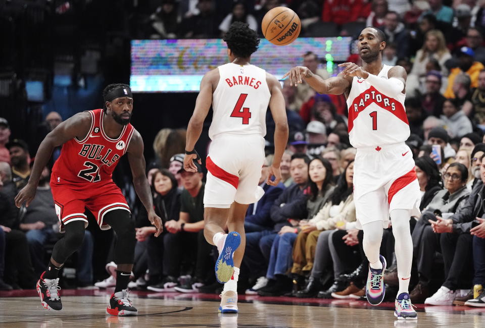 Toronto Raptors forward Will Barton (1) passes the ball as Chicago Bulls guard Patrick Beverley (21) and Raptors forward Scottie Barnes (4) watch during the first half of an NBA basketball game Tuesday, Feb. 28, 2023, in Toronto. (Frank Gunn/The Canadian Press via AP)