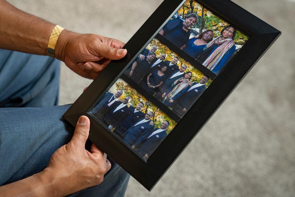 Eric Hayes holds pictures of his siblings at their mother's funeral Tuesday, June 6, 2023, at his Indianapolis home. They lost their mother to breast cancer. Out of nine children in his family, Hayes and one brother are the only ones never to have been diagnosed with some type of cancer. 