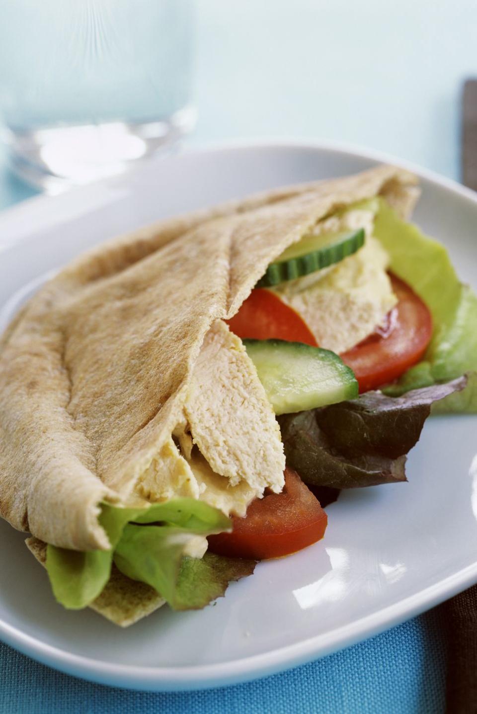 mediterranean diet lunch hummus pita sandwich with tomato and cucumber