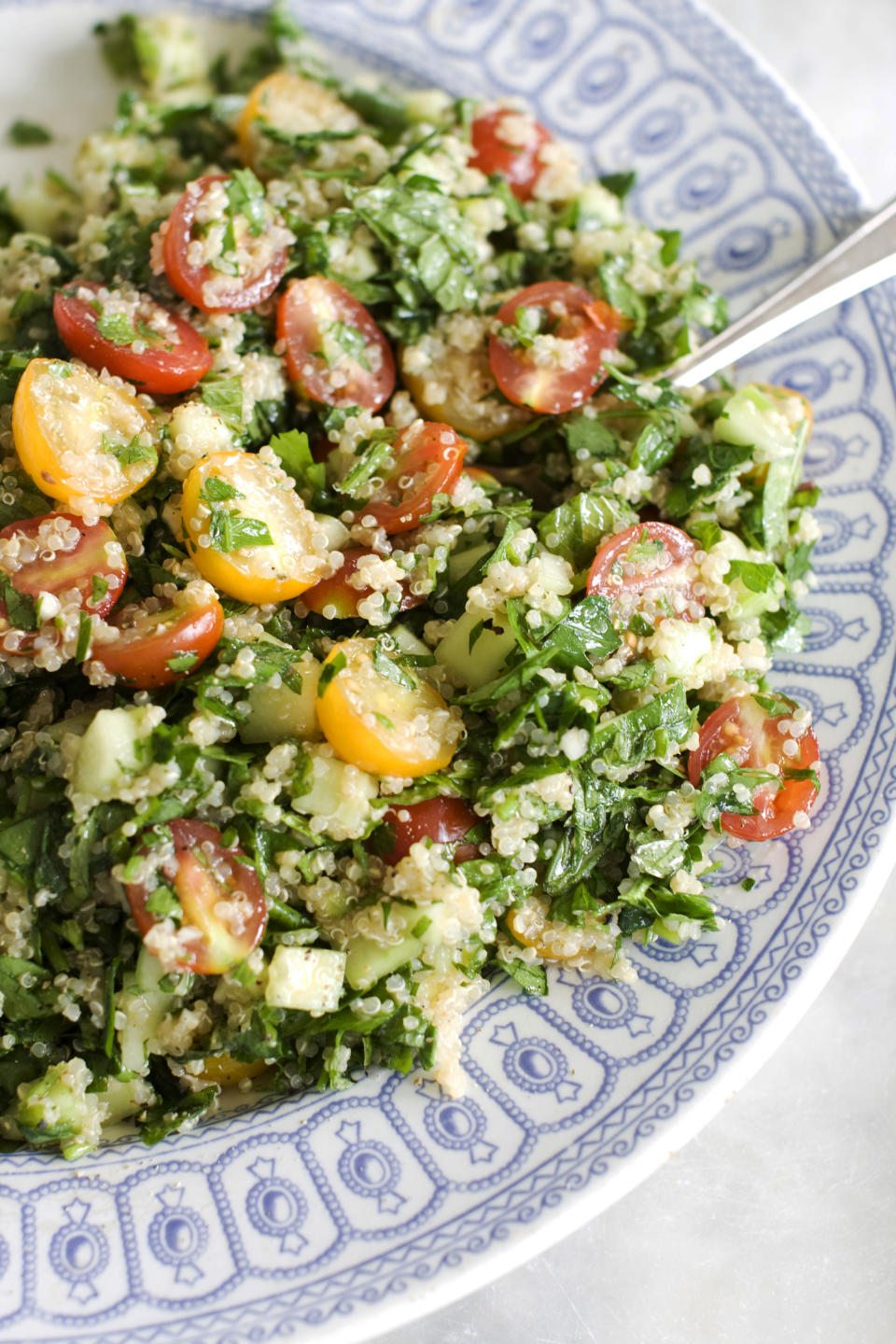 In this June 10, 2013 photo, quinoa tabbouleh is shown served in a bowl in Concord, N.H. Though everyone seems to have a different way of spelling tabbouleh _ toubouleh? tabouli? _ more and more people do seem to agree that this delicious Middle Eastern salad of bulgur wheat tossed with cucumbers, tomatoes, herbs, olive oil and lemon juice is delicious. (AP Photo/Matthew Mead)