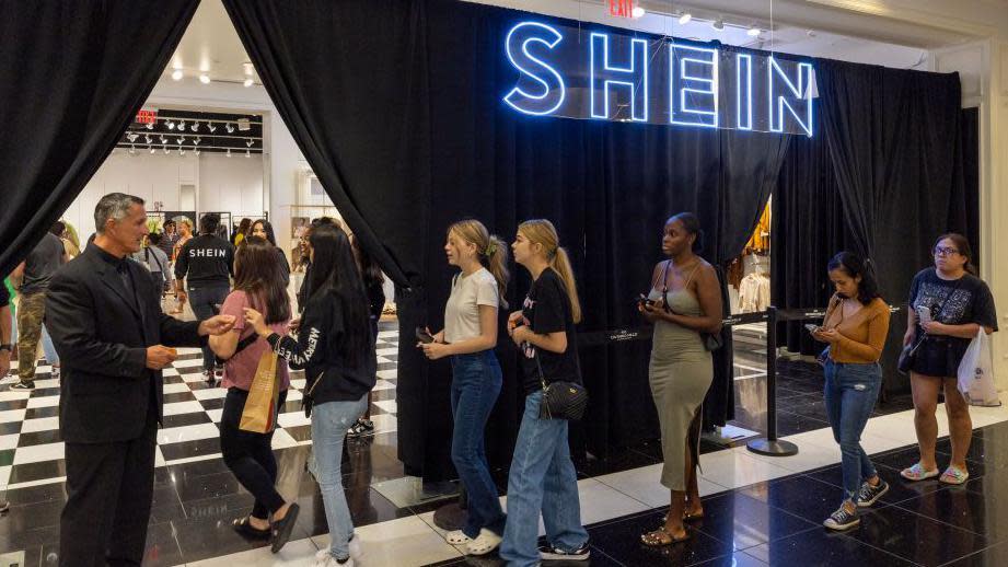 People enetring a Shein pop-up shop