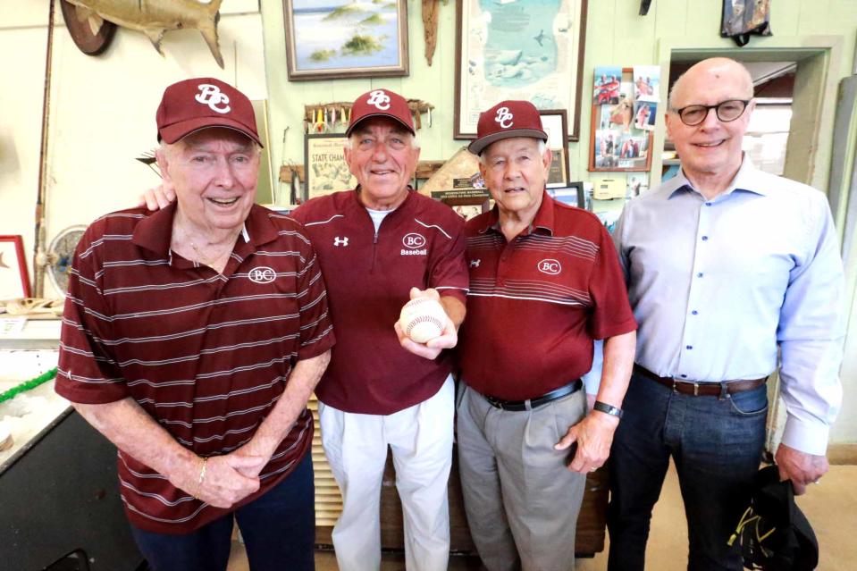 In this May 2021 file photo, Charlie Russo holds a ball autographed by Benedictine pitcher Carter Holton as he stands with with some of his teammates from the 1961 state championship baseball team: Denny Herb, Stan Friedman and coach Charlie Moore.