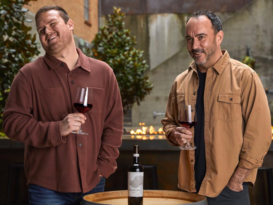 a man drinking a glass of wine with Dave Matthews