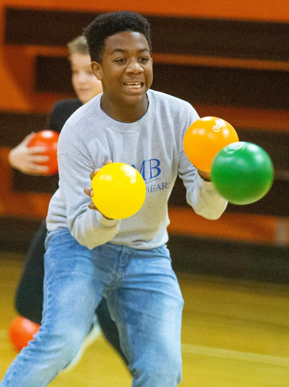 Kenneth Stroud, 13, dodges a ball while playing dodgeball at the Massillon Boys and Girls Club.