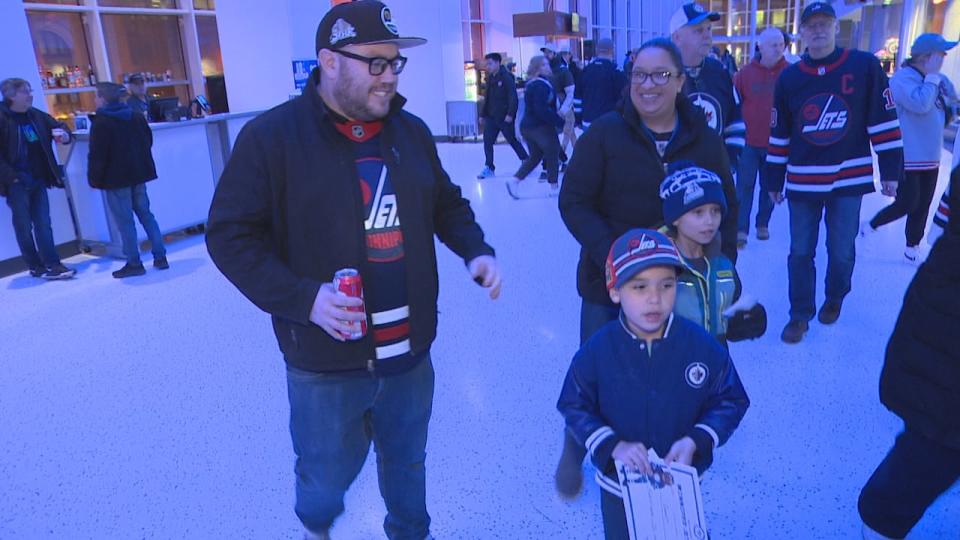 Ian and Hilary Moffatt and their sons Owen and Emmett head to their seats before the start of the St. Louis Blues vs. Winnipeg Jets game.