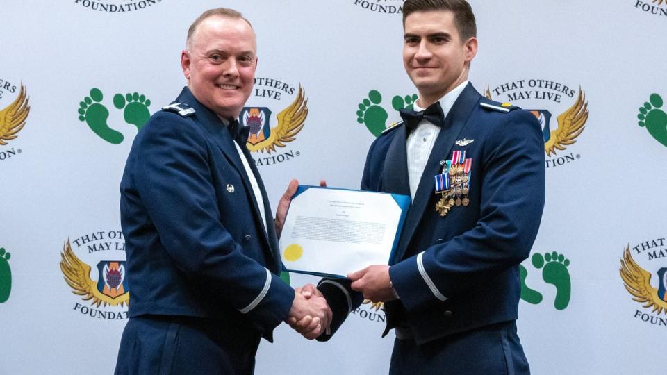 U.S. Air Force Maj. Mark Ross (right), an HH-60G Pave Hawk pilot previously with the 66th Rescue Squadron, was awarded the Distinguished Flying Cross at Nellis Air Force Base, Nev., Sept. 23, 2023. Ross led the last U.S. Air Force HH-60G helicopters out of Afghanistan on Aug. 29, 2021. (Airman 1st Class Elizabeth Tan/Air Force)