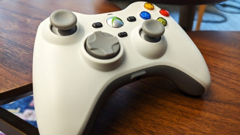 A replica of an Xbox 360 controller sits on a table.