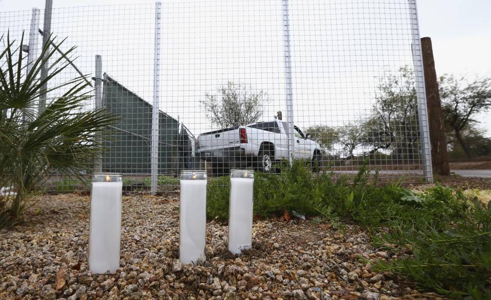 A makeshift memorial is set up near a home where a Phoenix woman was arrested on suspicion of killing her three children after they were found dead inside the family home Tuesday, Jan. 21, 2020, in Phoenix. (AP Photo/Ross D. Franklin)