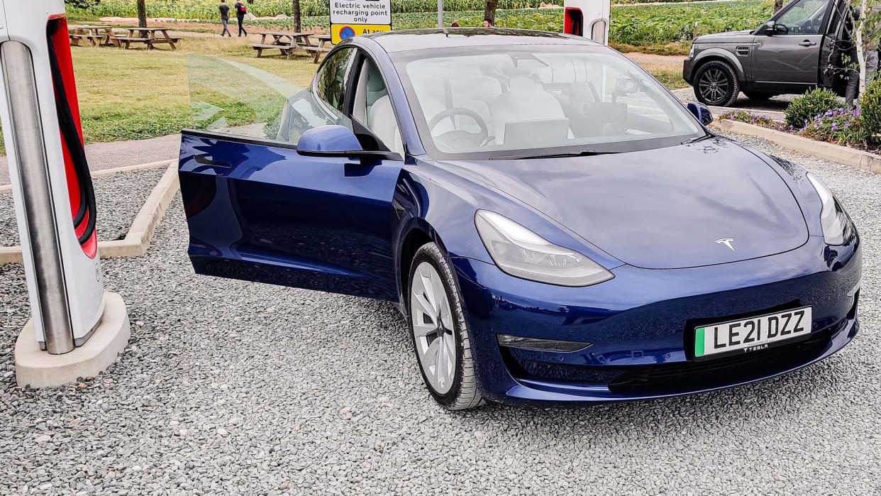  Tesla Model 3 parked in charging station. 