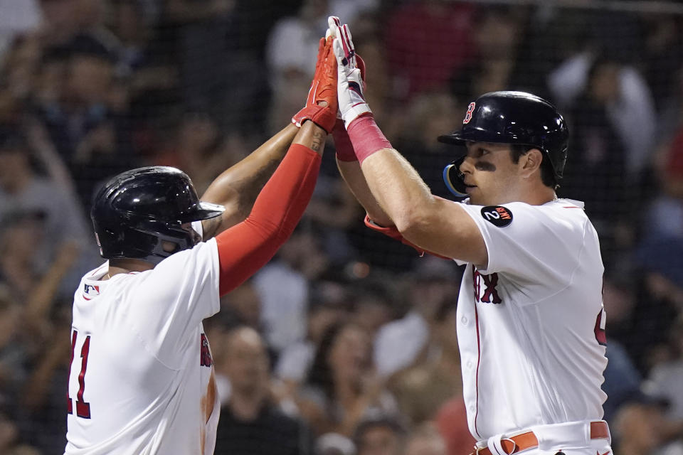 Boston Red Sox's Rafael Devers, left, celebrates with Triston Casas after Casas hit a two-run home run against the New York Yankee during the second inning of a baseball game Tuesday, Sept. 13, 2022, in Boston. (AP Photo/Steven Senne)