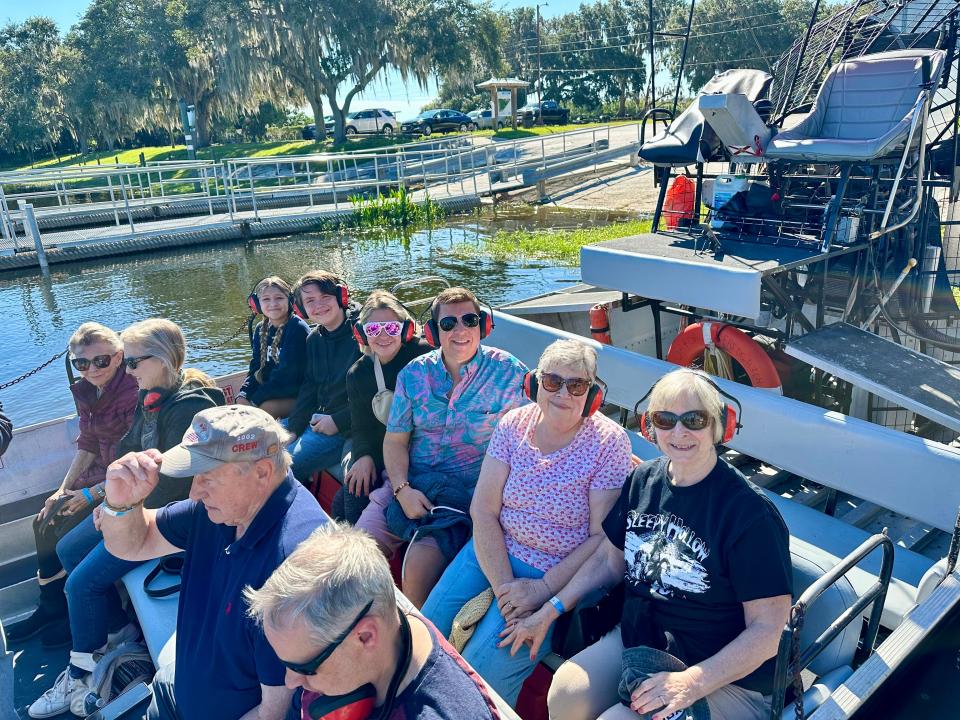 People sitting on an airboat.