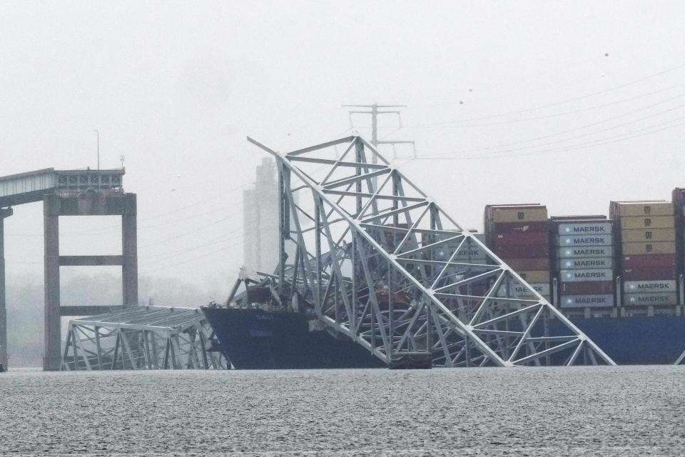 A container ship rests against the wreckage of the Francis Scott Key Bridge on Thursday, March 28, 2024, in Baltimore, Md. After days of searching through murky water for the workers missing after the bridge collapsed, officials are turning their attention Thursday to what promises to be a massive salvage operation. (AP Photo/Matt Rourke)