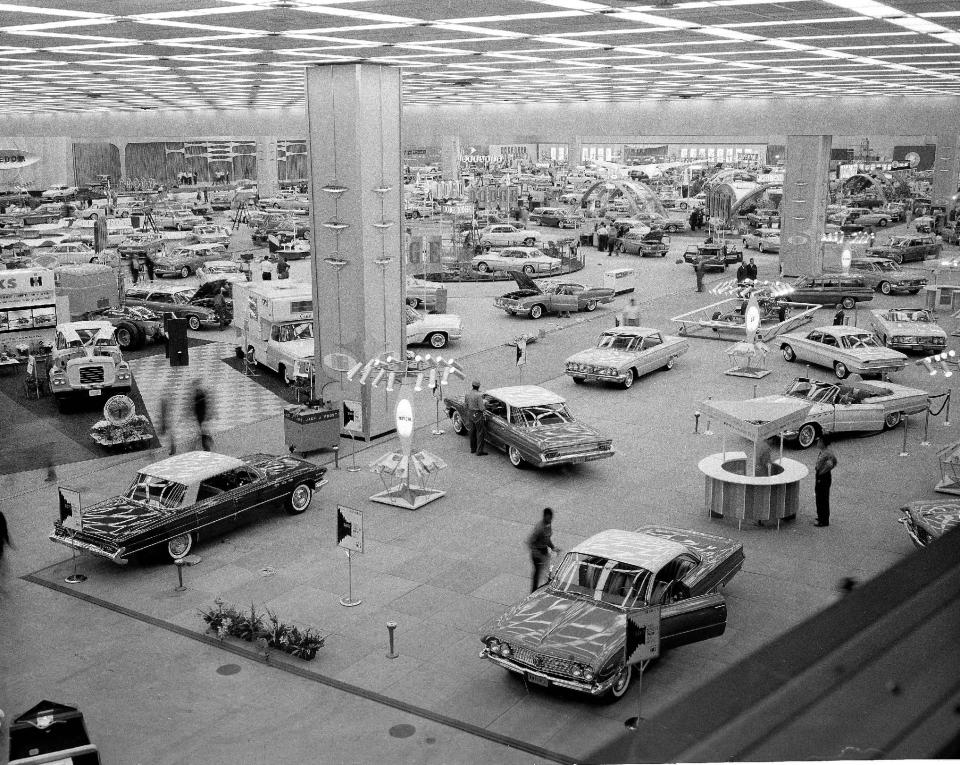 FILE -In this Oct. 14, 1960 file photo, people visit the National Auto Show at Cobo Hall in Detroit. In 2013, more than 795,000 people, including 5,200 journalists from around the world attended the show. (AP Photo/File)