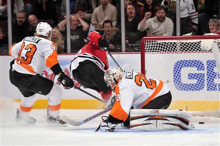 Dec 11, 2013; Chicago, IL, USA; Philadelphia Flyers goalie Ray Emery (29) fails to make a save on a goal scored by Chicago Blackhawks center Michal Handzus (26) during the second period at the United Center. Rob Grabowski-USA TODAY Sports