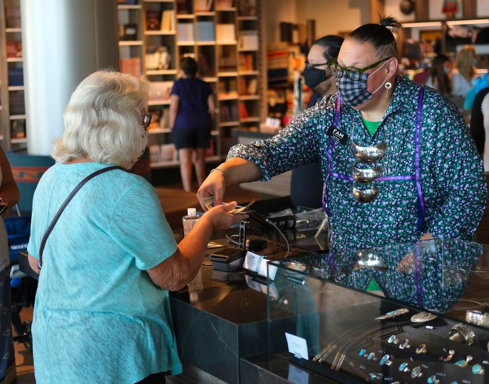 Tom Farris makes a sale in the FAM Store during the opening day of the First Americans Museum on Sept. 18, 2021.