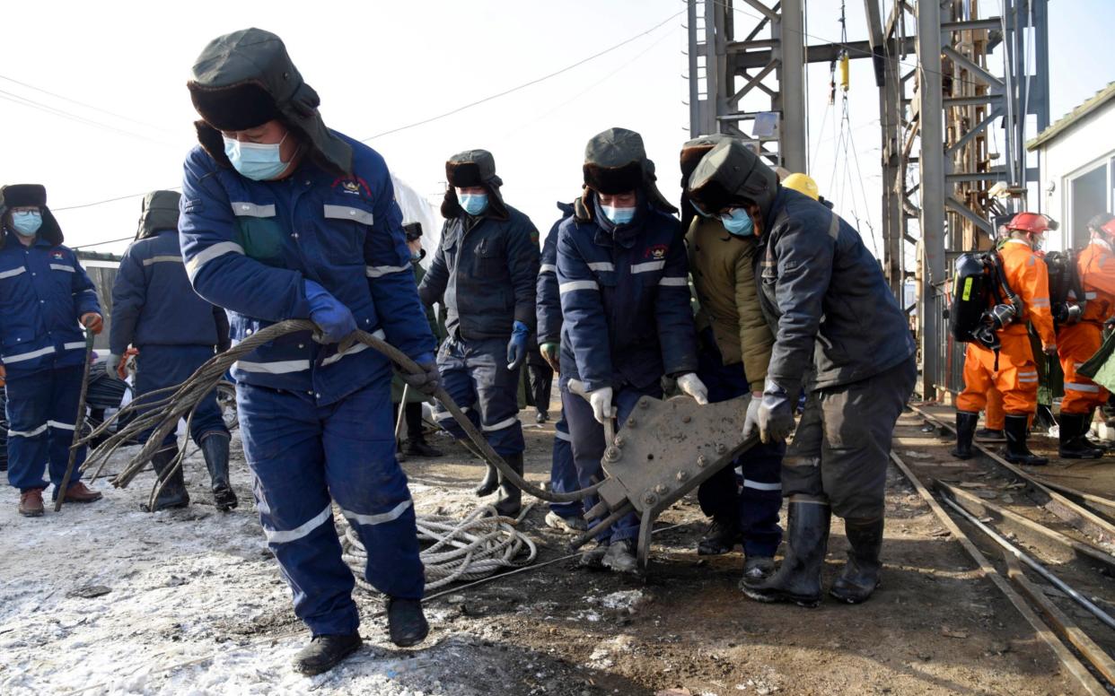 Rescuers work at the site of a gold mine that suffered an explosion in Qixia in eastern China's Shandong Province