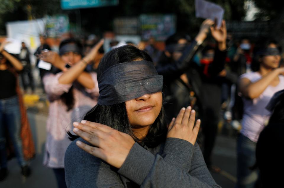 Protestors wearing blindfolds take part in a protest in solidarity with rape victims and to oppose violence against women in India, in New Delhi, India December 7, 2019. REUTERS/Adnan Abidi