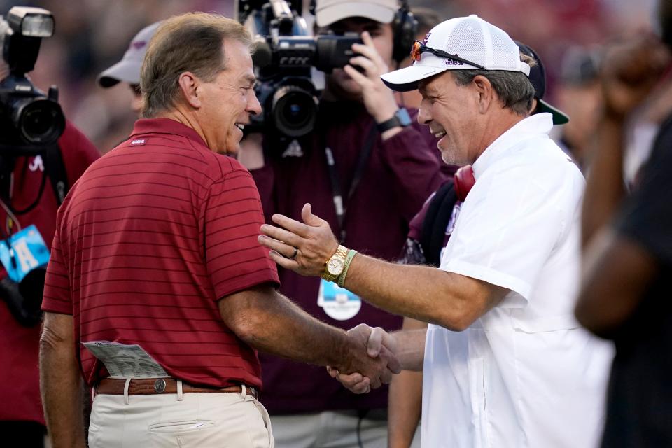 Alabama coach Nick Saban, left, and Texas A&M coach Jimbo Fisher, right, shake hands prior to their game on Saturday, Oct. 9, 2021, in College Station, Texas.