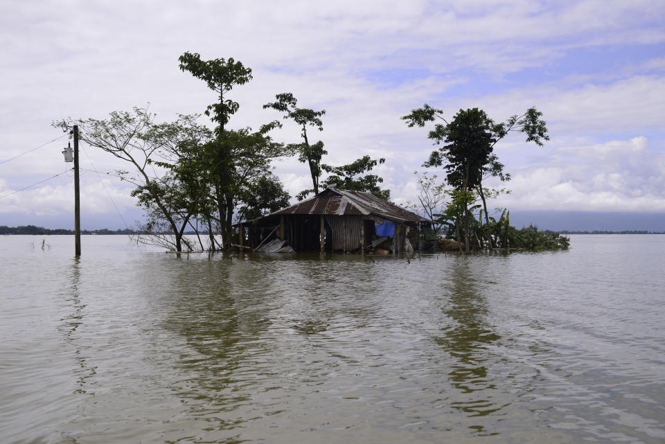 A house is surrounded by flood waters in Sylhet, Bangladesh, Wednesday, June 22, 2022. (AP Photo/Mahmud Hossain Opu)