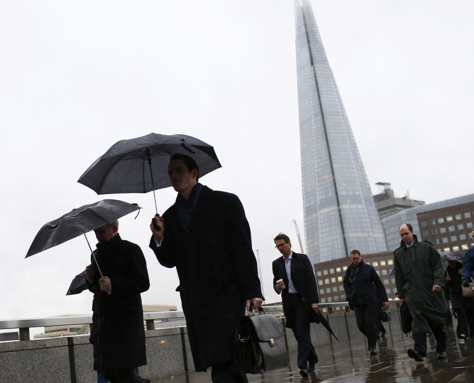 The Shard is seen as workers use umbrellas to shelter themselves from the rain while crossing London Bridge in London February 28, 2014. London's financial services sector created 25 percent more jobs in February than a year ago, new data has shown, indicating the industry may be recovering from the restructuring and redundancies prompted by the financial crisis. After a strong January, the City hiring market showed no signs of slowing down last month, with 3,220 new jobs created, compared with 2,575 added in February 2013, according to financial services recruiter Astbury Marsden. The data suggests London's banks and financial services companies are returning to growth after slashing thousands of jobs in the face of a lengthy recession and a series of industry scandals that followed the financial crisis. Picture taken February 28, 2014. REUTERS/Eddie Keogh (BRITAIN - Tags: BUSINESS EMPLOYMENT)    ATTENTION EDITORS: PICTURE 10 OF 25 FOR PACKAGE 'CITY OF LONDON - LIFE IN THE SQUARE MILE'. TO FIND ALL IMAGES SEARCH 'RECRUITER KEOGH'