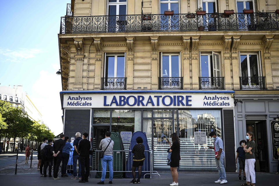 Image: People stand in line as they wait for a COVID-19 test in Paris. (Christophe Archambault / AFP - Getty Images)