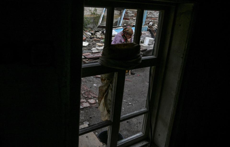 Nina Gonchar, sits in front of a destroyed house in Bohorodychne village in Kramatorsk, Donetsk region, on 13 September 2022, amid the Russian invasion of Ukraine (AFP via Getty Images)