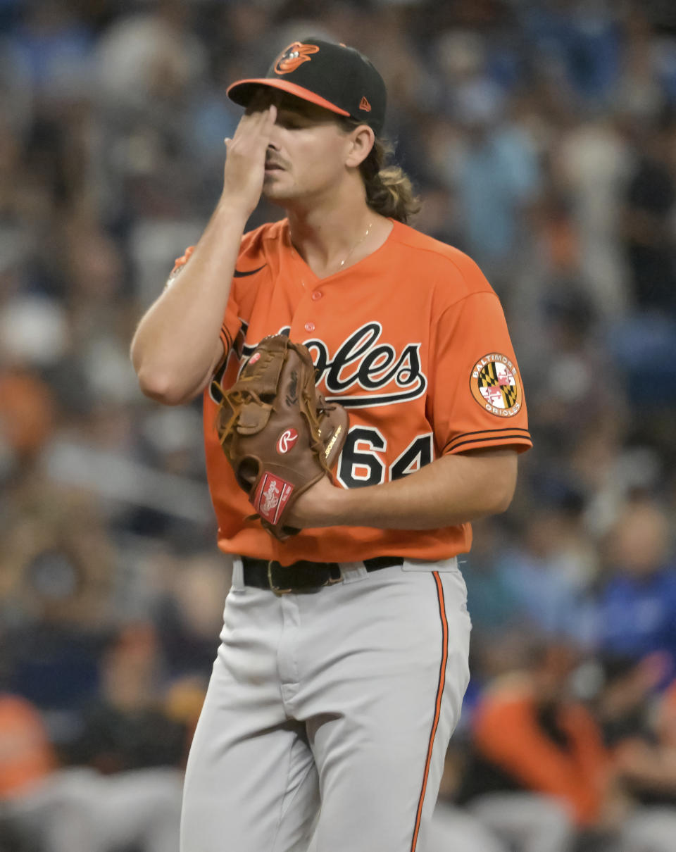 Baltimore Orioles starter Dean Kremer wipes his brow during the third inning of a baseball game against the Tampa Bay Rays Saturday, July 16, 2022, in St. Petersburg, Fla. (AP Photo/Steve Nesius)