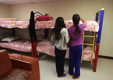 Girls stand in a dorm at the shelter for underage immigrants and repatriated minors "Mexico, my home" in Ciudad Juarez May 27, 2014. REUTERS/Jose Luis Gonzalez