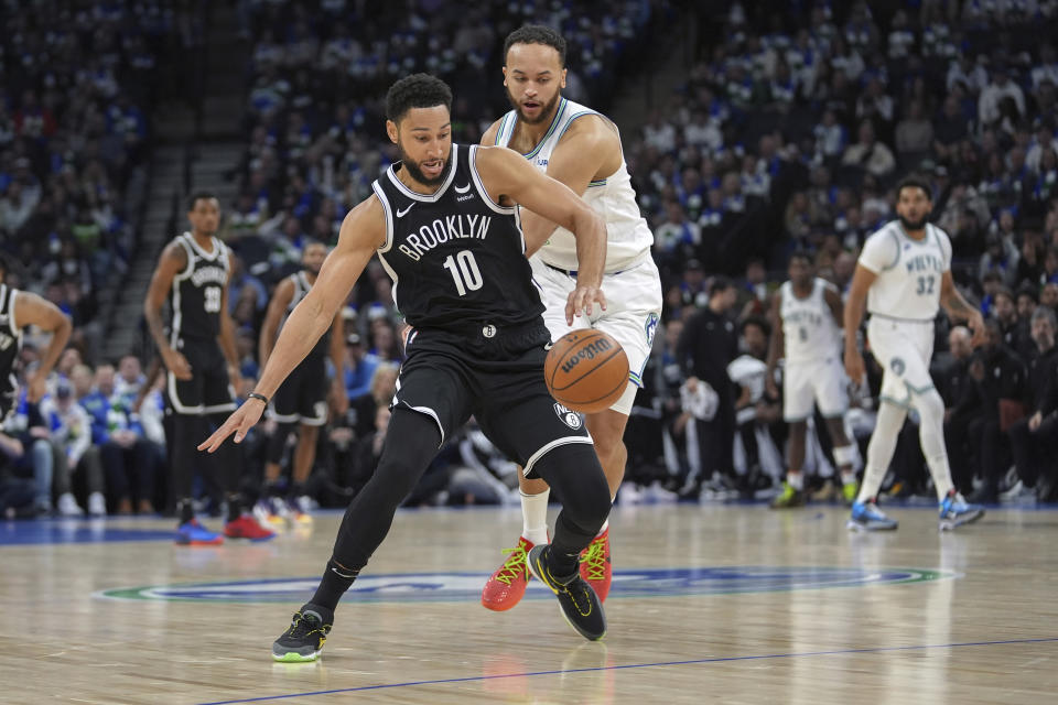 Brooklyn Nets guard Ben Simmons (10) loses control of the basketball as Minnesota Timberwolves forward Kyle Anderson defends during the first half of an NBA basketball game Saturday, Feb. 24, 2024, in Minneapolis. (AP Photo/Abbie Parr)