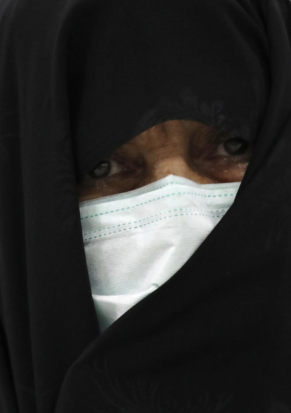 A woman wearing a protective face mask to help prevent the spread of the coronavirus waits to receive her Covid-19 vaccine at a vaccination center at Iran Mall in Tehran, Iran, Monday, Aug. 9, 2021. Iran — like much of the world — remains far behind countries like the United States in vaccinating its public. So far only 3 million people out of Iran's population of 80 million have had both vaccine doses. (AP Photo/Vahid Salemi)