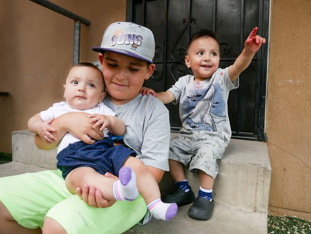<p>Matt Dahlseid/The New Mexican</p> “I couldn’t see, so I followed the baby’s crying,” says Asaya (center, with cousin Armani, left, and Joe, right).