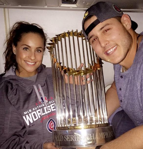 Anthony Rizzo and fiancee Emily Vakos pose with the World Series trophy. (Anthony Rizzo on Twitter)