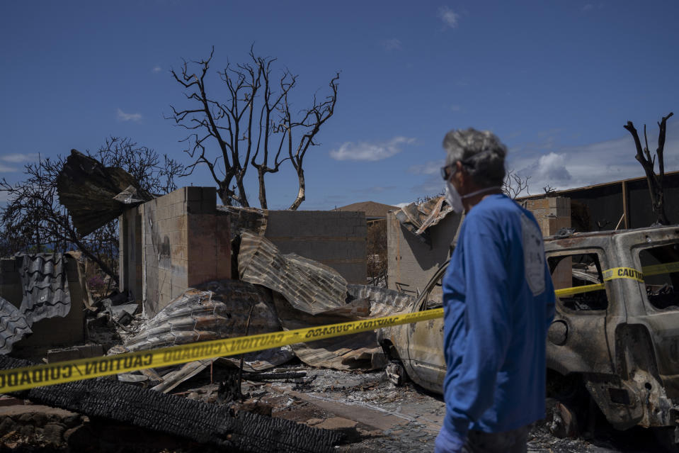 FILE - Michael Vierra looks at his house for the first time after the wildfire in August, on Tuesday, Sept. 26, 2023, in Lahaina, Hawaii. Hawaii's top public utility officials and the president of Hawaiian Electric are expected to testify Thursday, Sept. 28, in a congressional hearing about the role the electrical grid played in last month's deadly Maui wildfire. (AP Photo/Mengshin Lin, File)