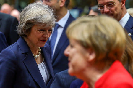 Prime Minister Theresa May (L) and German Chancellor Angela Merkel attend a European Union leaders summit in Brussels, Belgium October 20, 2016. REUTERS/Yves Herman