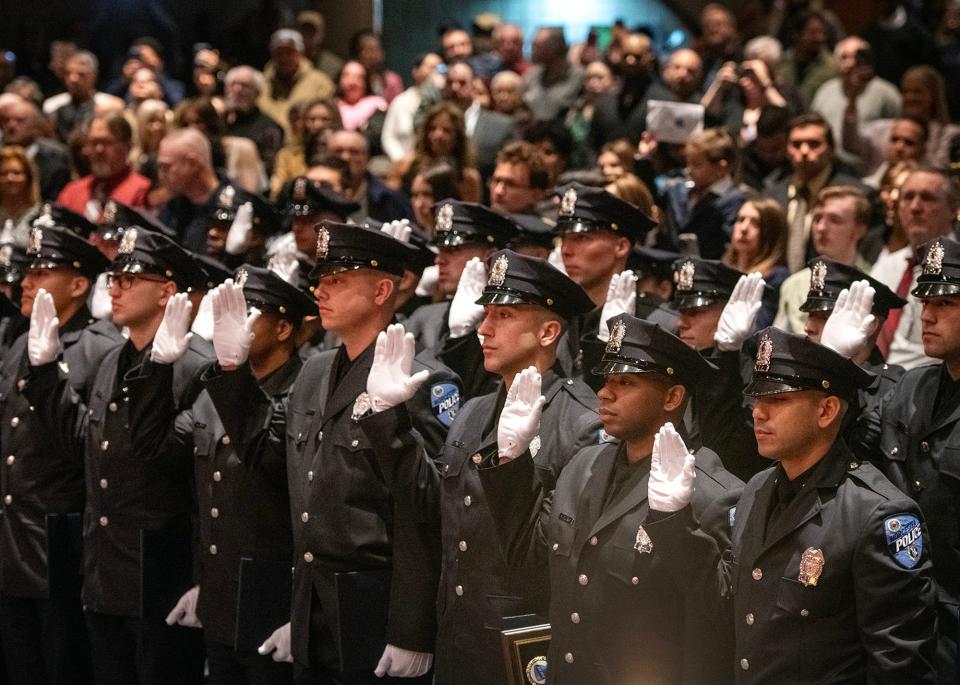 New Worcester police officers are sworn in during the Recruit Class 09-22 Graduation held Friday at Worcester Technical High School. Twenty-eight police academy graduates will become Worcester Police officers, and four others will join other area departments.