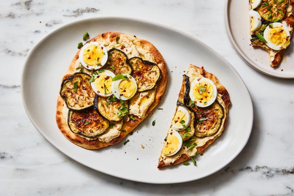 Toast flatbread and spread with hummus, grilled or roasted vegetables, and sliced hard-boiled eggs.