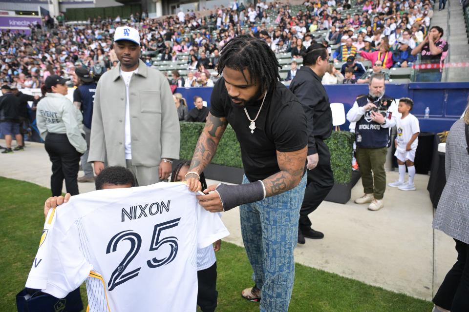 The Green Bay Packers' Keisean Nixon poses with a L.A. Galaxy jersey before the game against Inter Miami CF at Dignity Health Sports Park.