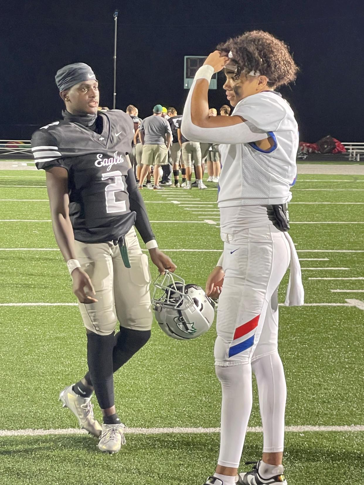 Zionsville receiver Eugene Hilton Jr. (left) and HSE receiver Donovan Hamilton (right) meet at midfield after both put on a show in the Royals' win Friday night.