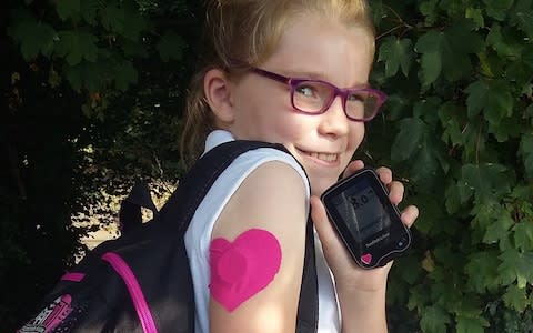 A diabetic schoolgirl with the FreeStyle Libre armpatch that detects blood sugar levels, and gives readouts on a smartphone-sized device