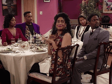 woman sitting at table signaling friends to stop