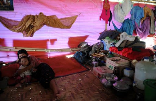 A Kachin mother and her child are seen in a refugee camp in May. hina has pushed thousands of refugees from Myanmar's Kachin minority back across the border into a province wracked by fighting between government troops and ethnic guerillas, the rebels said Friday