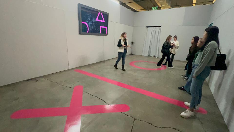 A room at the Squid Game: The Trials event where players had to stand on an "X" or an "O" to continue the game.