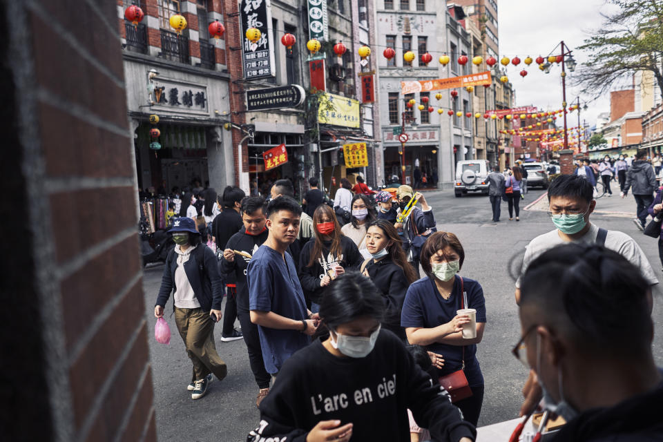 Shoppers walk beneath lanterns strung up on February 10, 2021 as people prepare for Chinese New Year at Dihua Street in Taipei, Taiwan. 